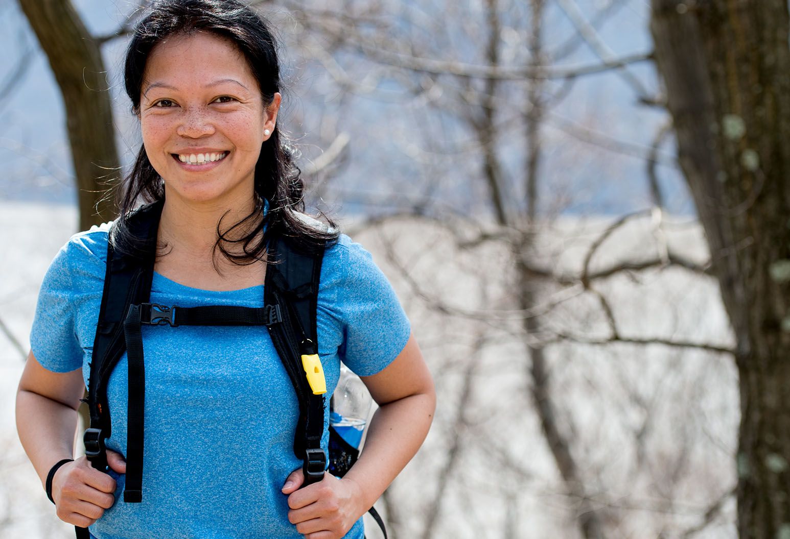 Woman standing outdoors in hiking gear
