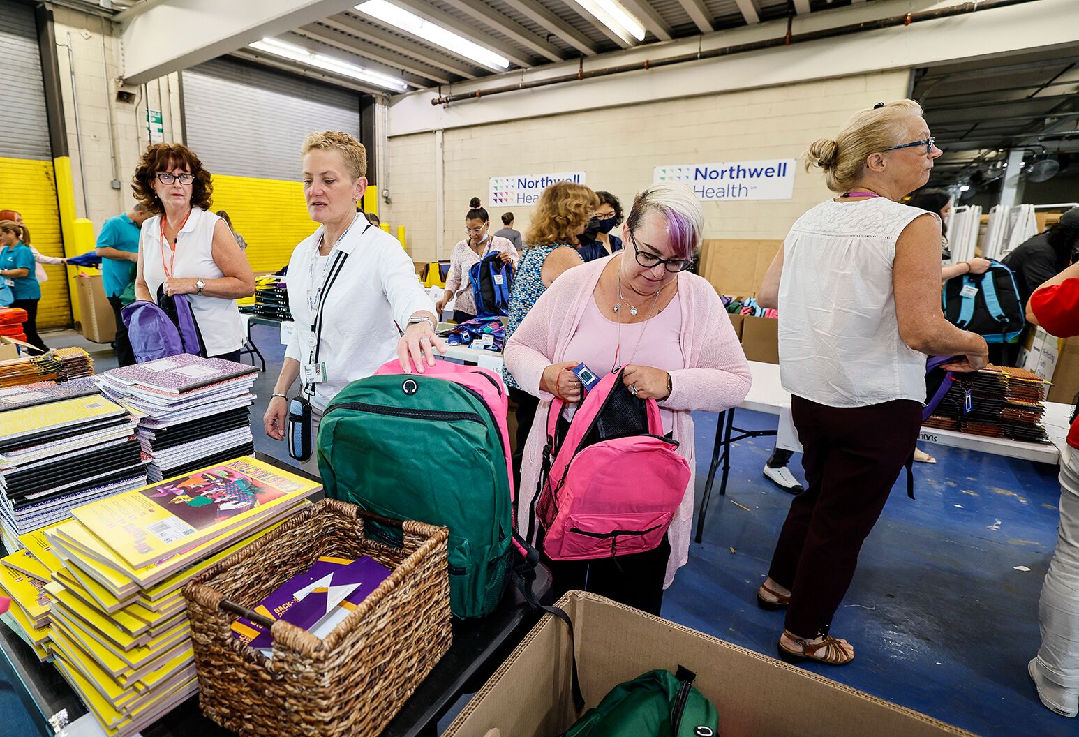 Northwell Health volunteers delivering 483 backpacks filled with school