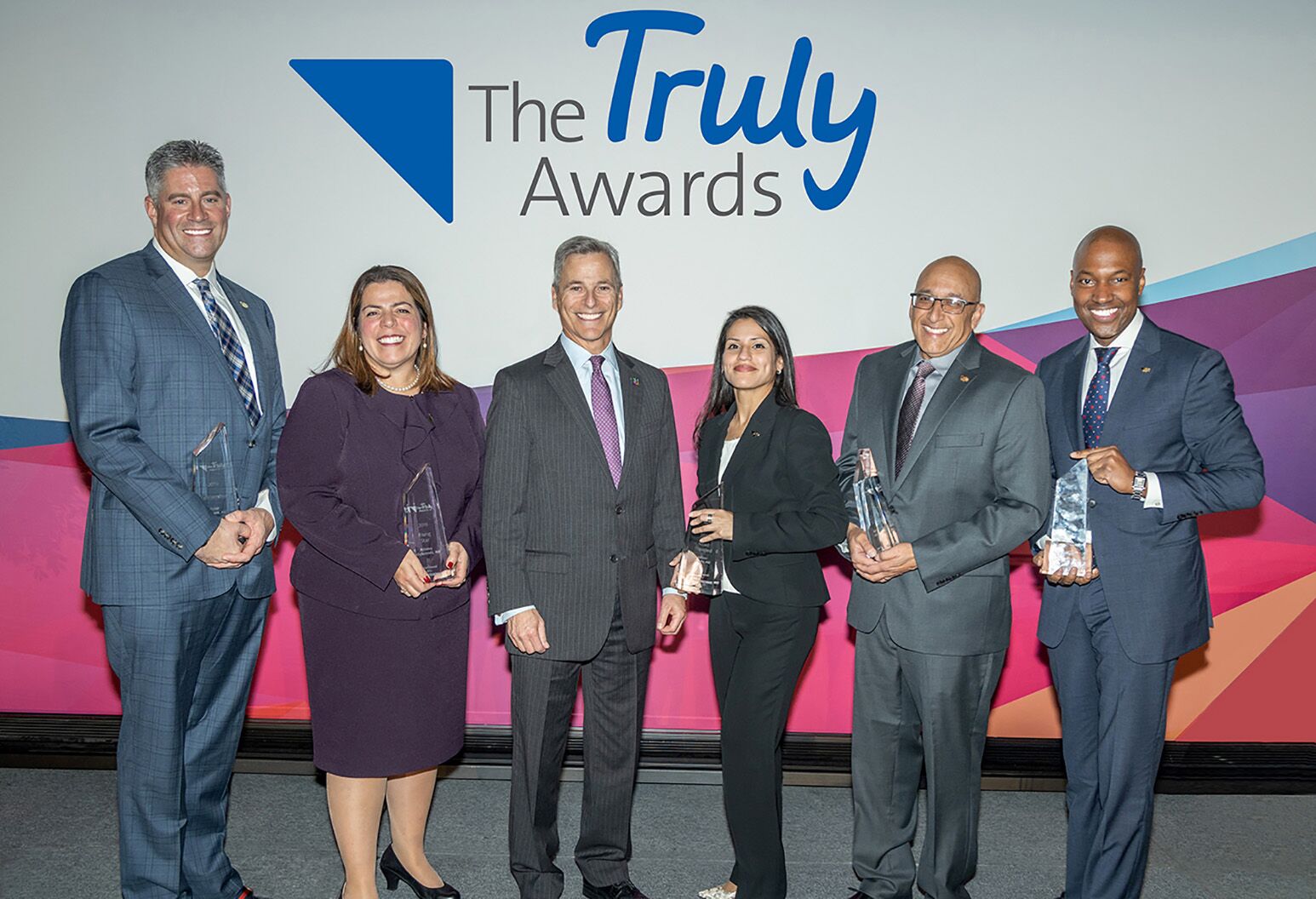 Truly Award recipients holding their awards