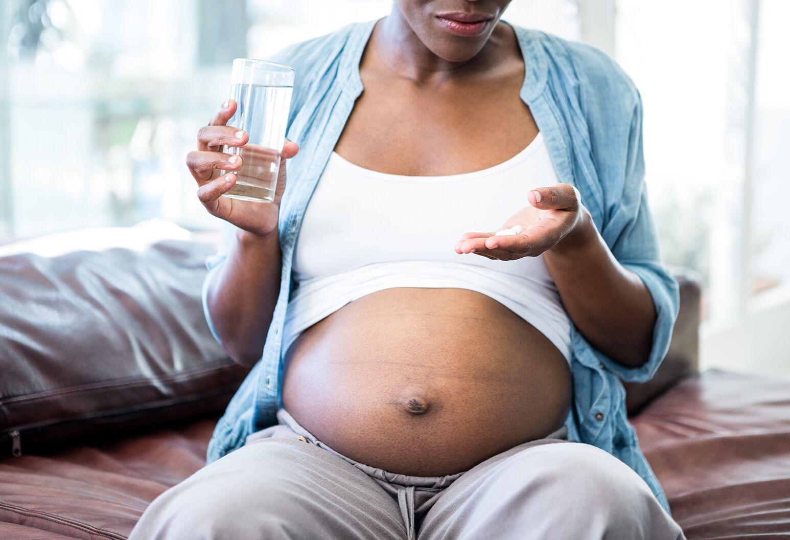 a-pregnant-woman-snuggling-in-bed-with-the-words-cold-and-cough-during