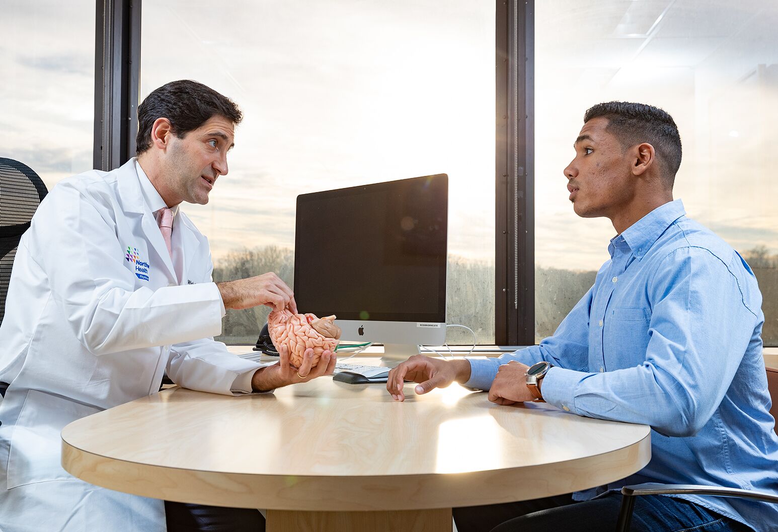 David Weintraub, MD, speaks with a patient about deep brain stimulation