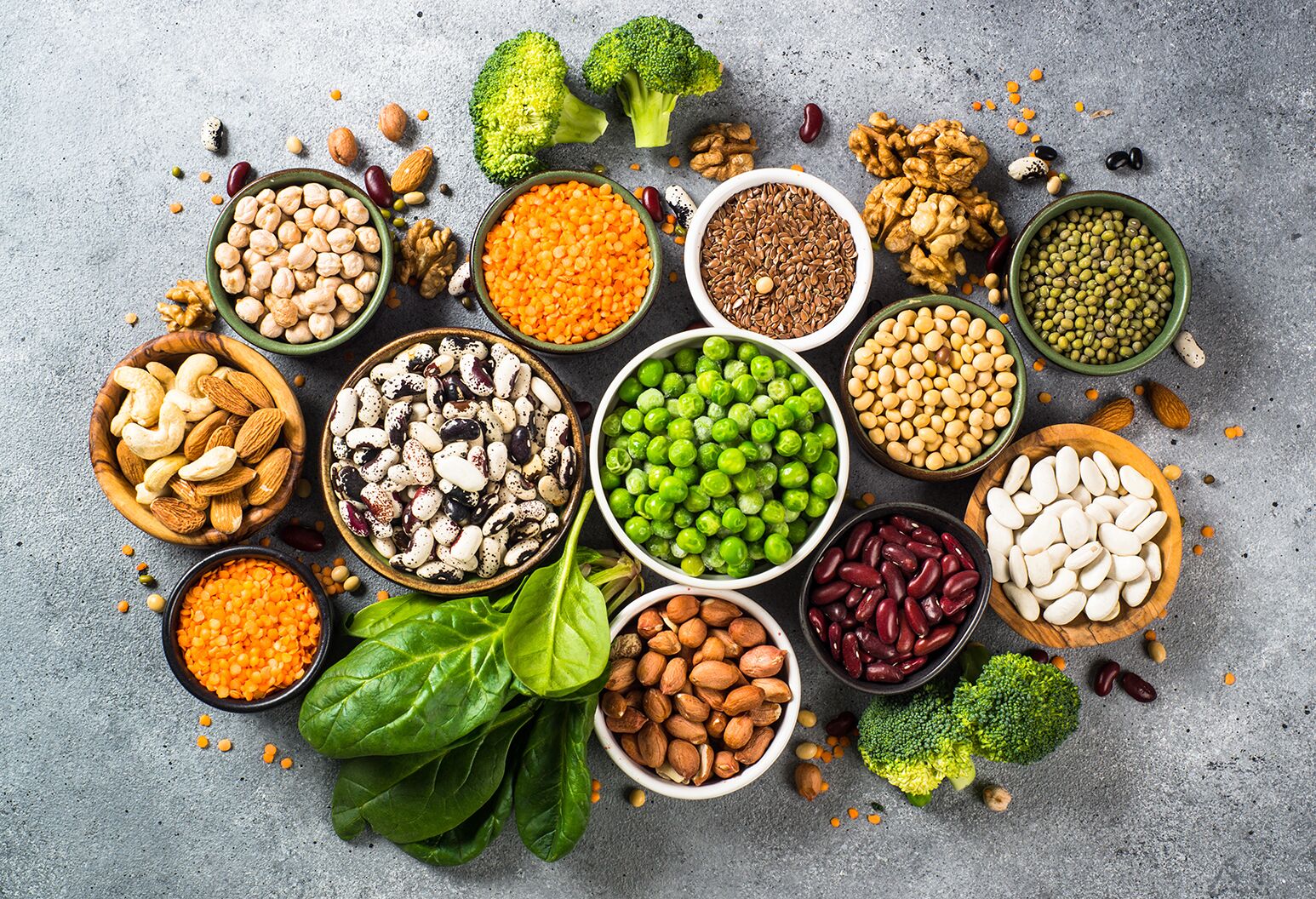 Variety of plant-based proteins including beans, nuts, and vegetables.