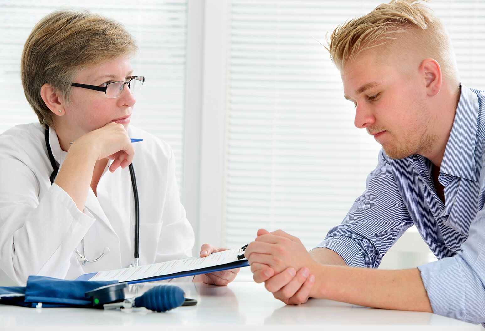 Physician consulting with male patient.