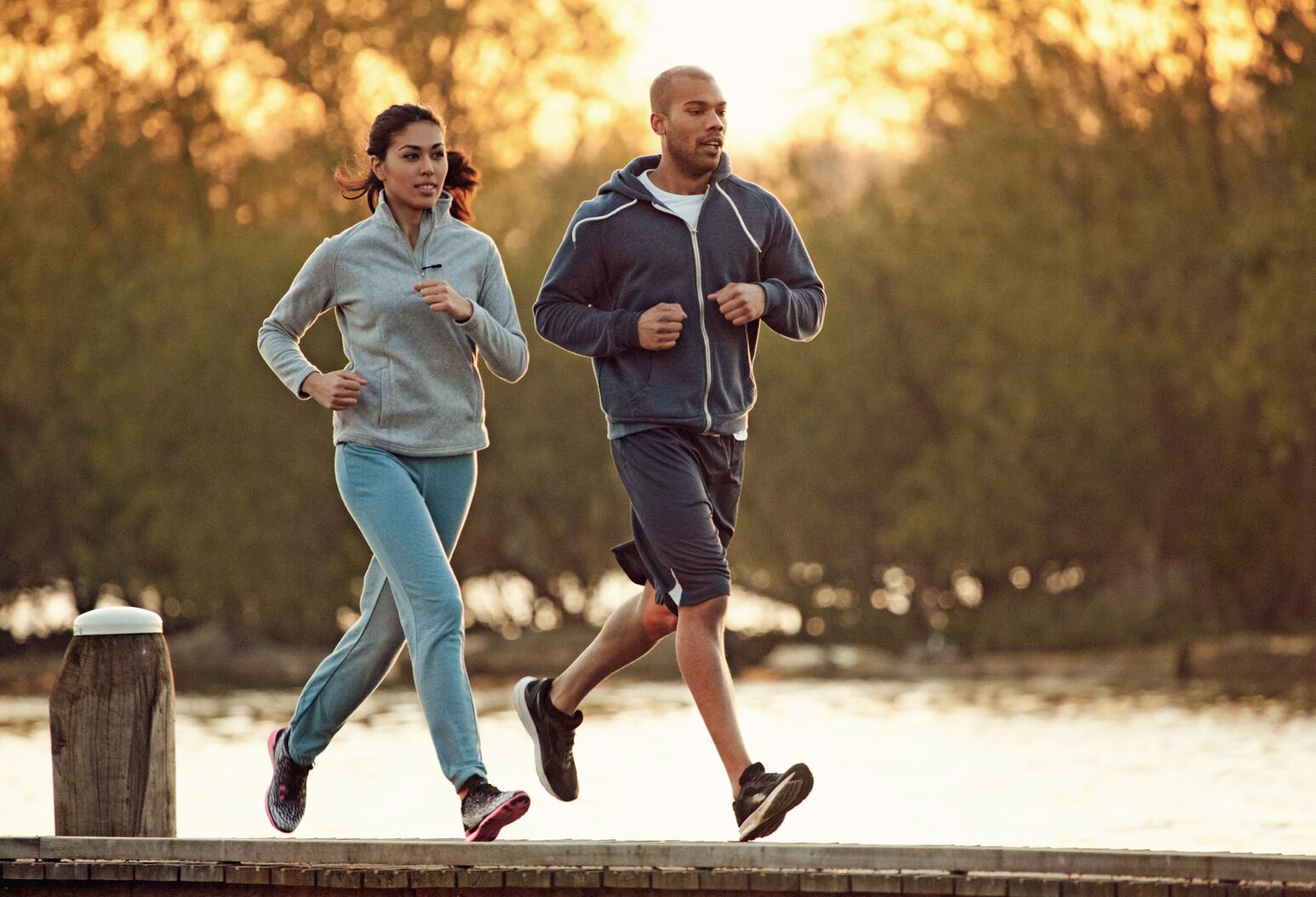 Jogging couple. African american persons man and woman running