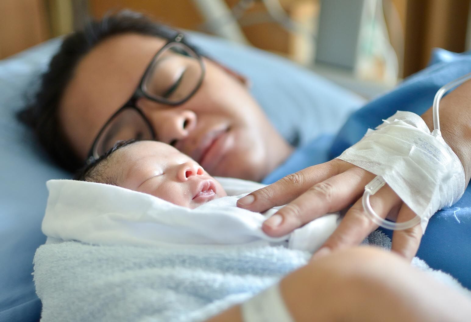 Asian mother with newborn baby in the hospital