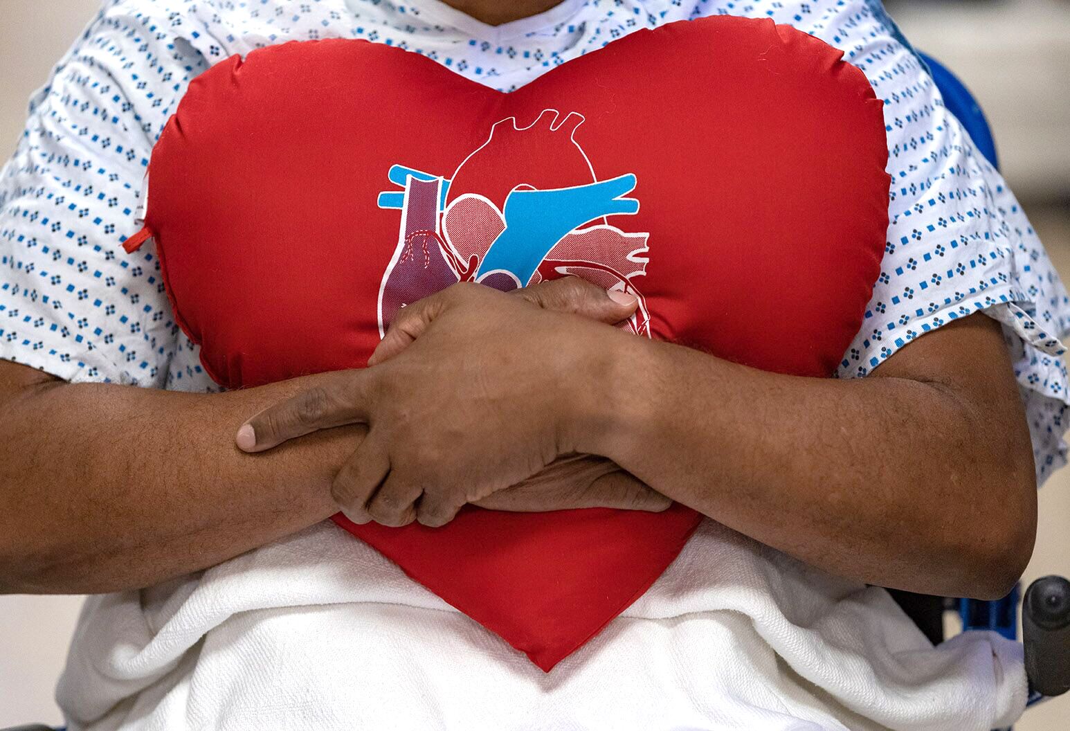 Patient holding a heart shaped pillow