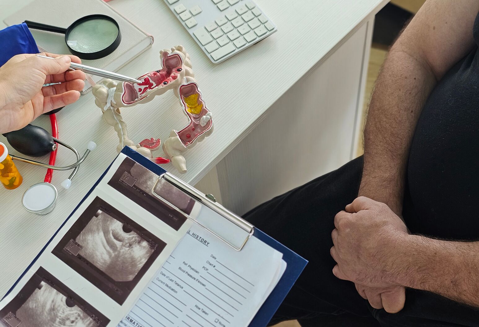 A doctor reviewing colonoscopy results with a patient.