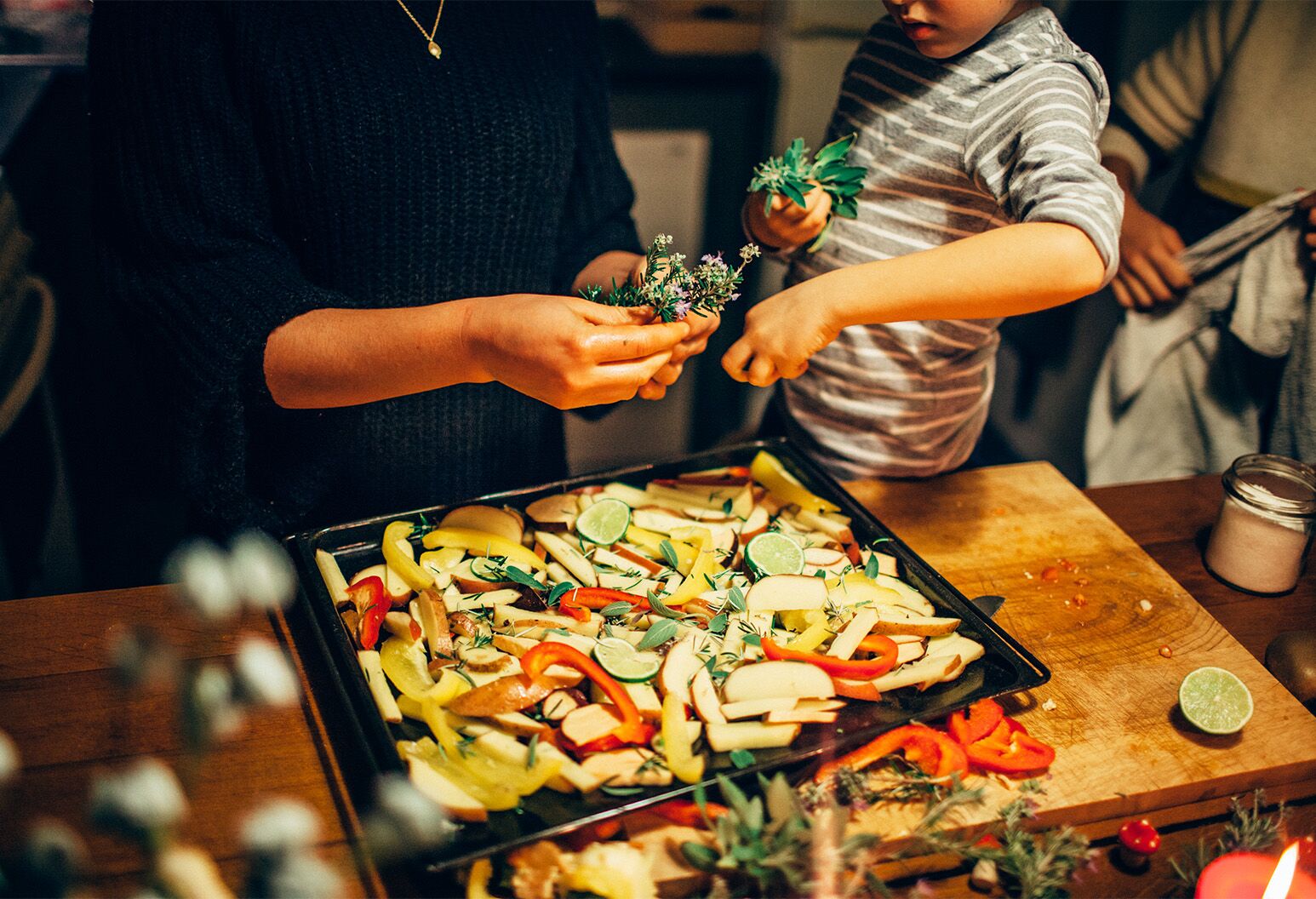 Two beautiful woman and young boy cooking holiday meal in kitchen / Algarve, Portugal. Part of a series.